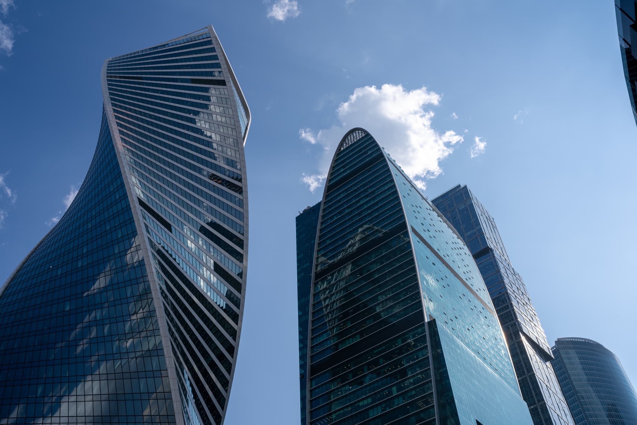 Modern Skyscrapers with Reflective Glass Facades Under a Bright Sky